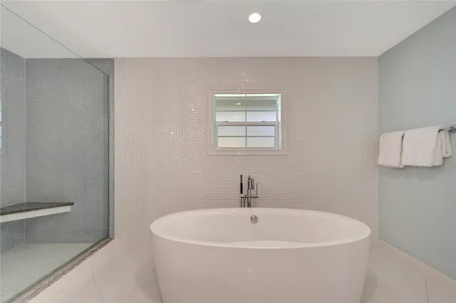 a white bath tub sitting in a bathroom
