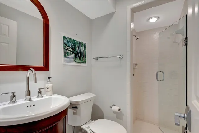 a bathroom with a sink toilet and shower