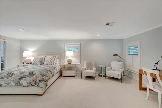 a spacious bedroom with a bed and a couch