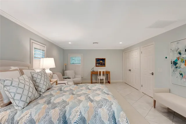 a spacious bedroom with a bed and a couch