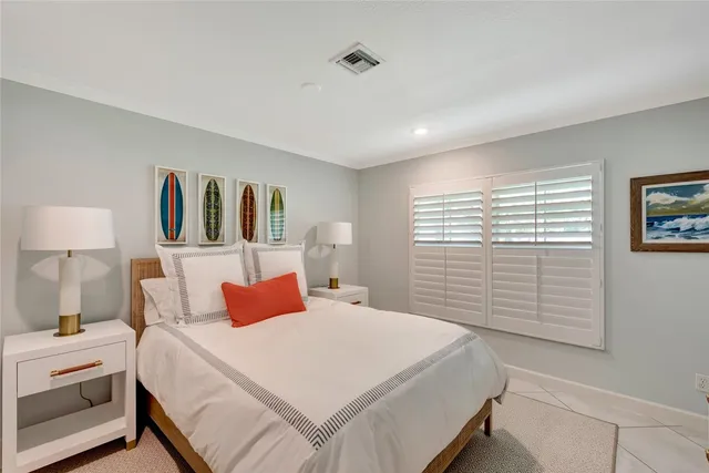 a bedroom with a bed and a night stand