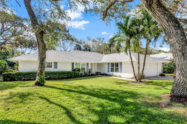 a view of a house with yard and tree s