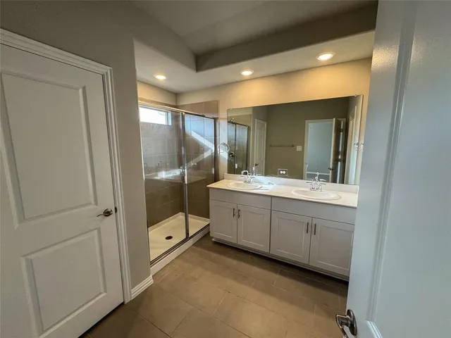 a bathroom with a double vanity sink and mirror
