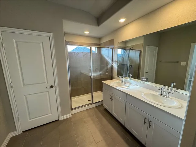 a bathroom with a double vanity sink and mirror