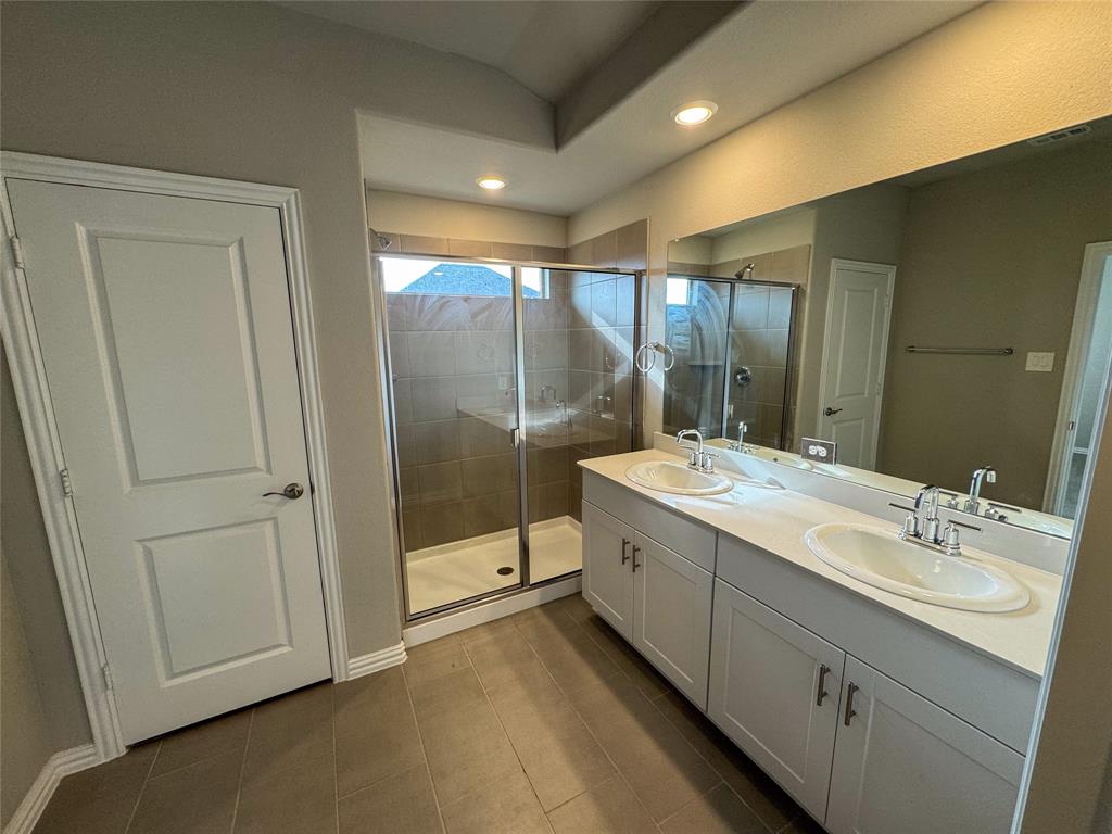 2110 Dunbar Drive Sherman, TX 75092 - Photo 13 of 22 a bathroom with a double vanity sink and mirror