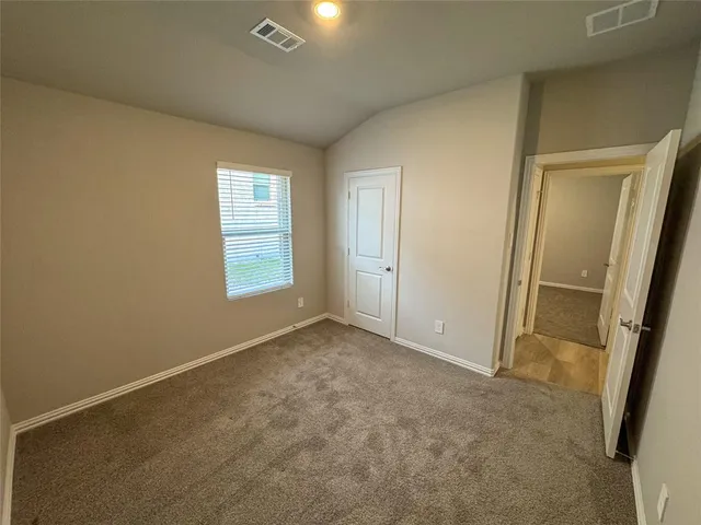 an empty room with windows and closet