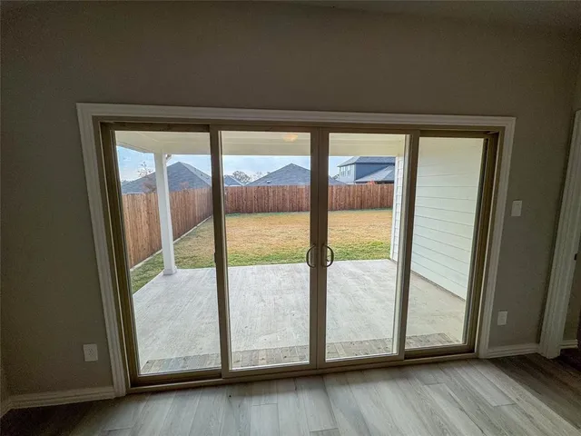 a view of an empty room and wooden floor