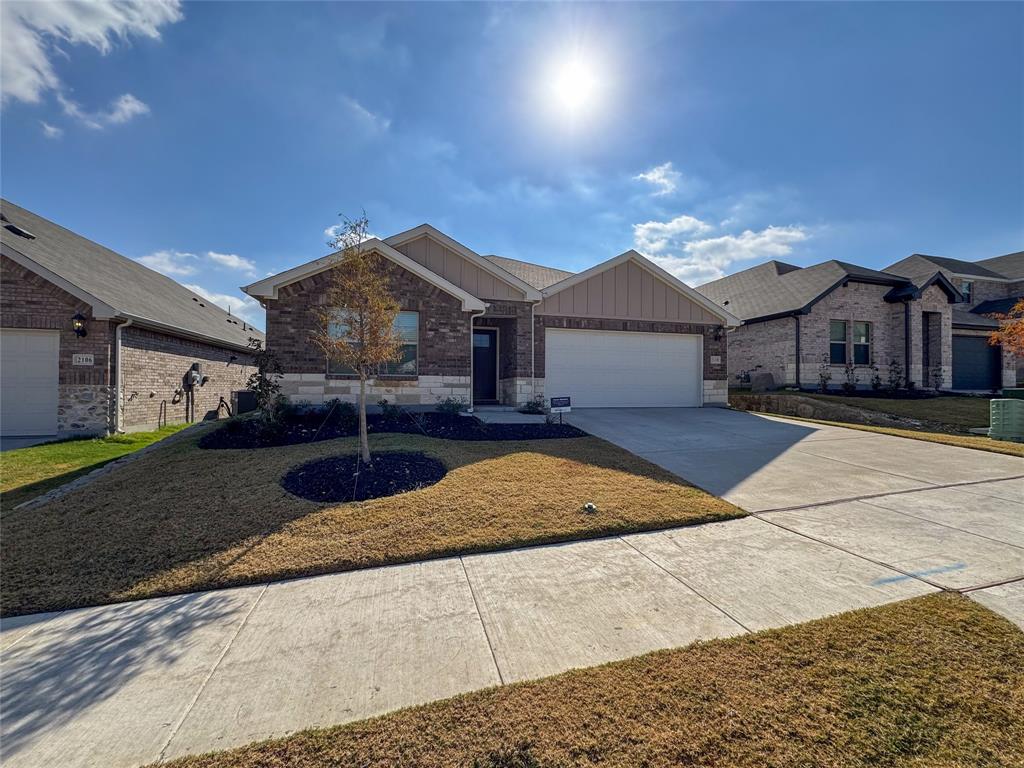 2110 Dunbar Drive Sherman, TX 75092 - Photo 2 of 22 a front view of a house with a yard and garage