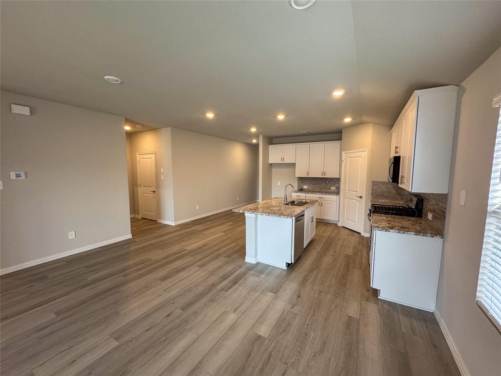 2110 Dunbar Drive Sherman, TX 75092 - Photo 5 of 22 a kitchen with a refrigerator and a stove top oven