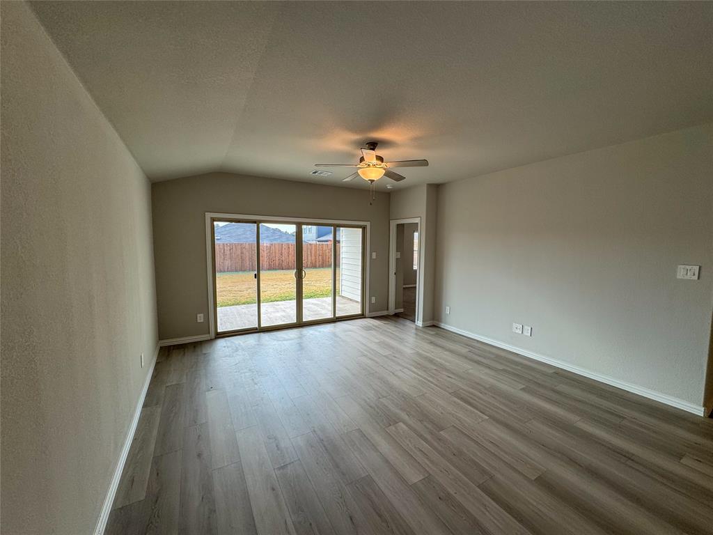 2110 Dunbar Drive Sherman, TX 75092 - Photo 9 of 22 a view of an empty room with wooden floor and a window