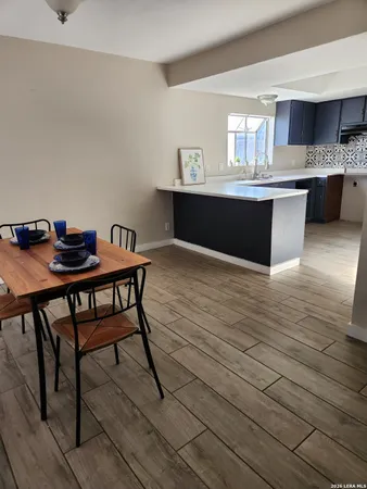 a kitchen with kitchen island stainless steel appliances a sink and cabinets