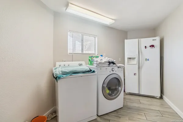 a utility room with sink dryer and washer