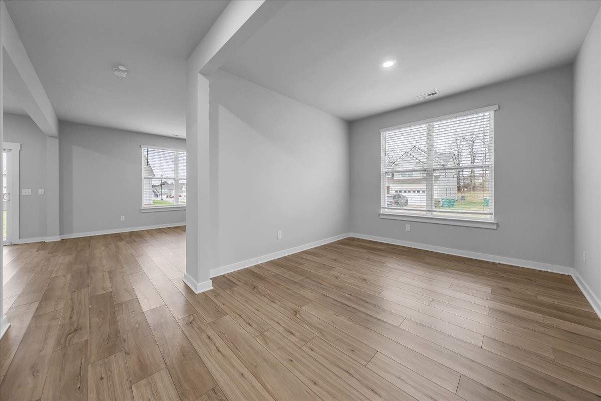 531 Mickelson Way Spring Hill, TN 37174 - Photo 11 of 57 an empty room with wooden floor and windows
