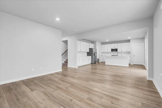 a view of a kitchen with a sink and a refrigerator