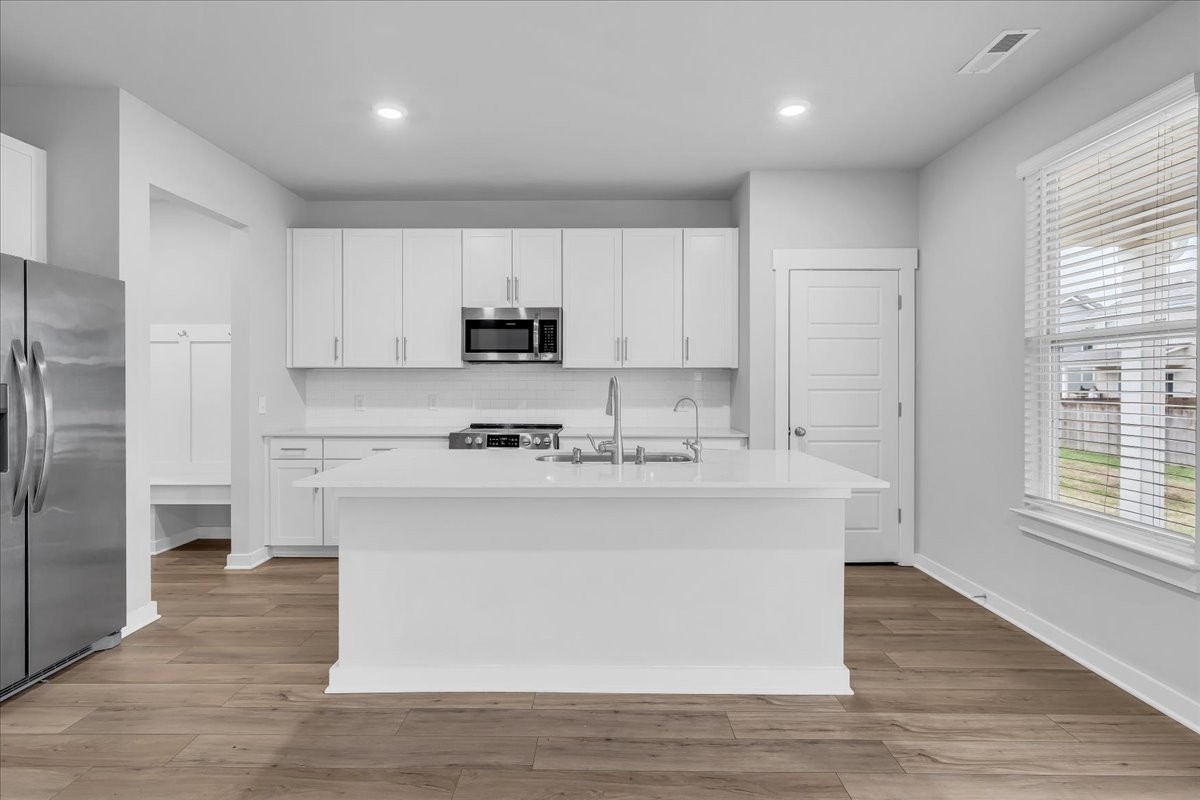 531 Mickelson Way Spring Hill, TN 37174 - Photo 20 of 57 a kitchen with stainless steel appliances a sink stove and refrigerator