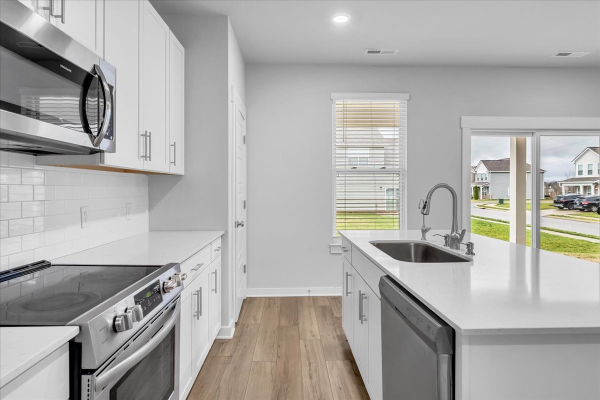 531 Mickelson Way Spring Hill, TN 37174 - Photo 22 of 57 a kitchen with stainless steel appliances granite countertop a sink and a stove