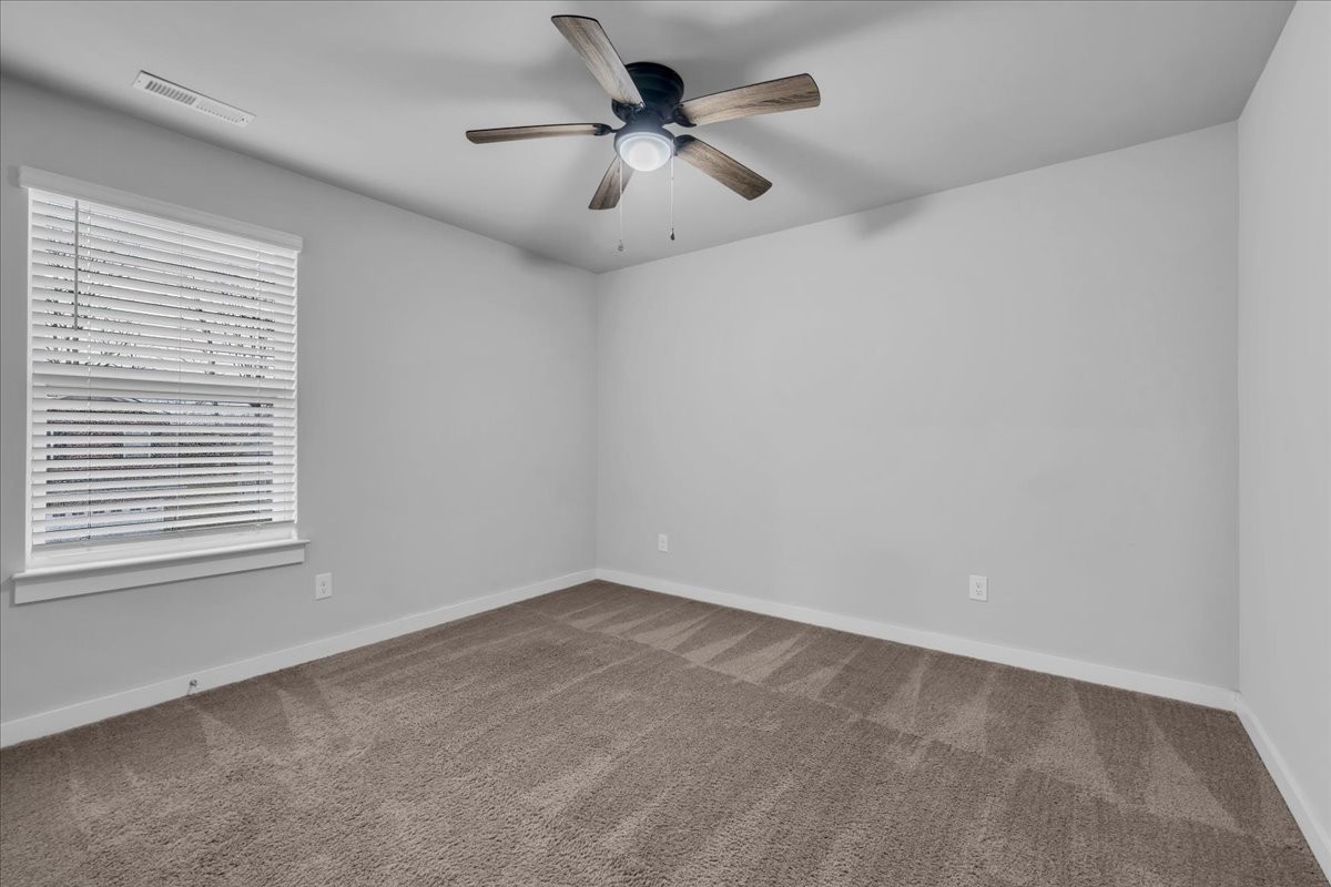 531 Mickelson Way Spring Hill, TN 37174 - Photo 32 of 57 an empty room with a chandelier fan and windows