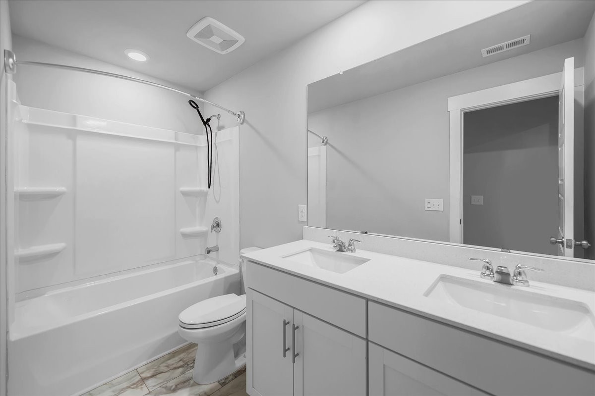 531 Mickelson Way Spring Hill, TN 37174 - Photo 42 of 57 a bathroom with a double vanity sink toilet mirror and bathtub