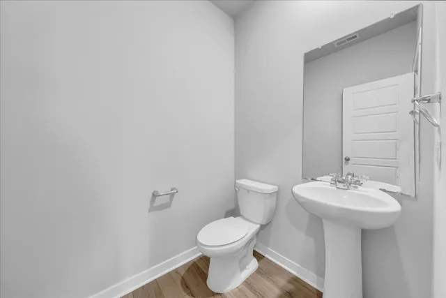 a bathroom with a sink a toilet and mirror