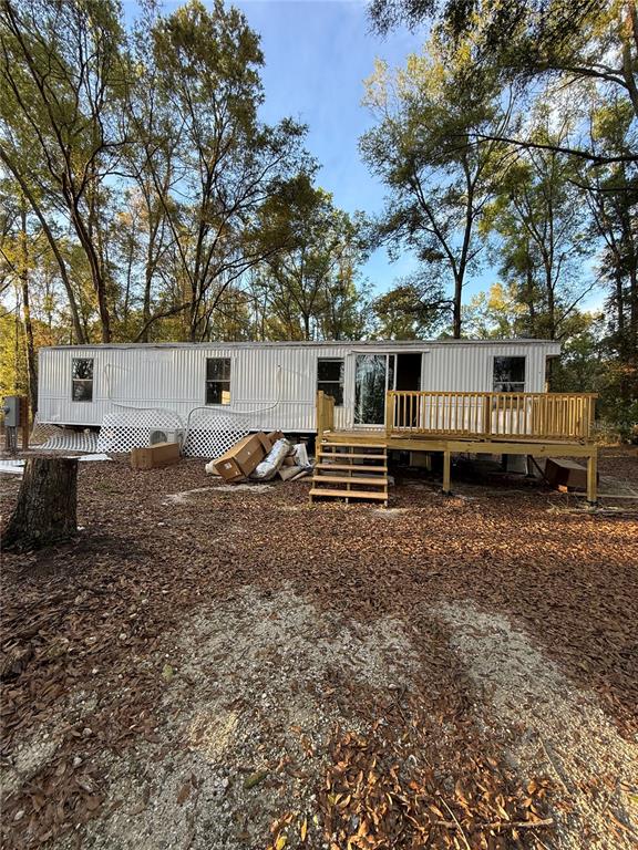 a backyard of a house with barbeque oven table and chairs