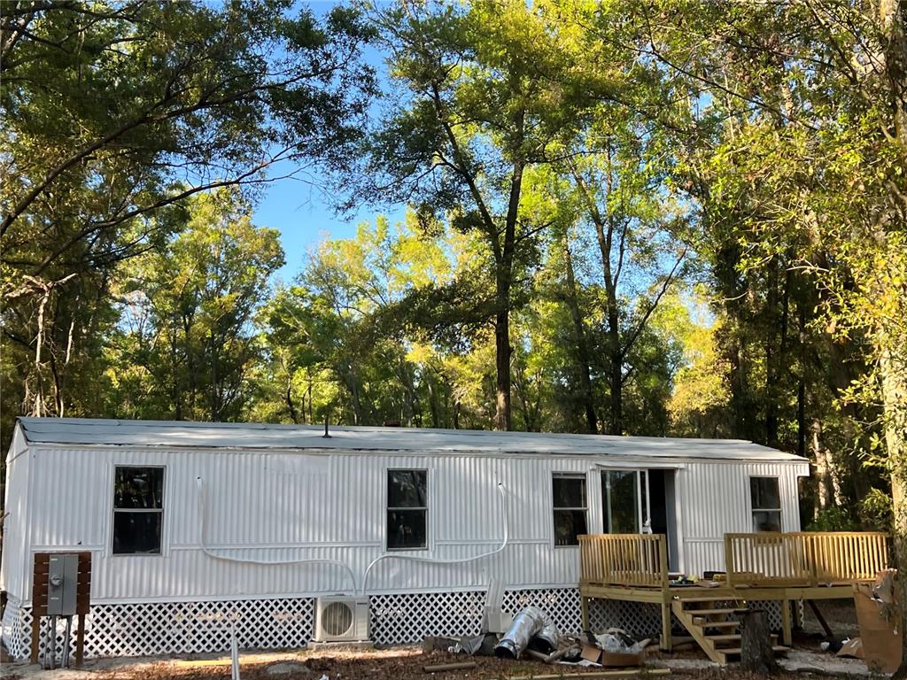 12941 208th Street O'Brien, FL 32071 - Photo 3 of 10 a side view of a house with a tree