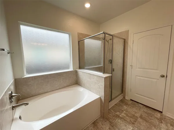 a bathroom with a tub and shower