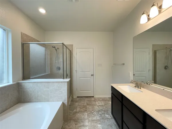 a bathroom with a bathtub and a sink