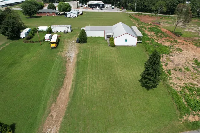 an aerial view of a house with a yard basket ball court and outdoor seating