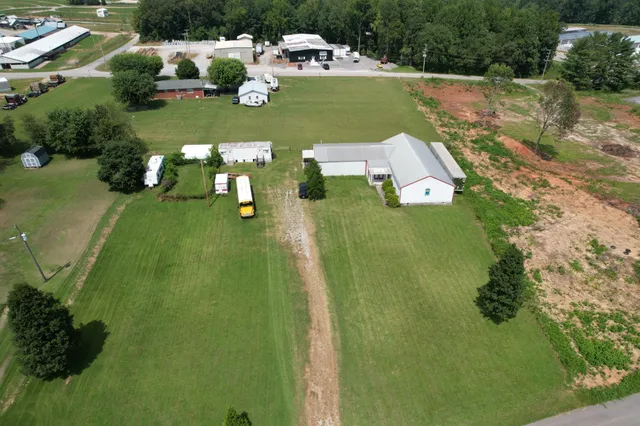 an aerial view of a house with a yard basket ball court and outdoor seating