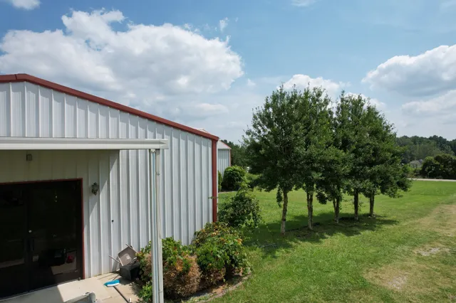 a backyard of a house with plants and trees