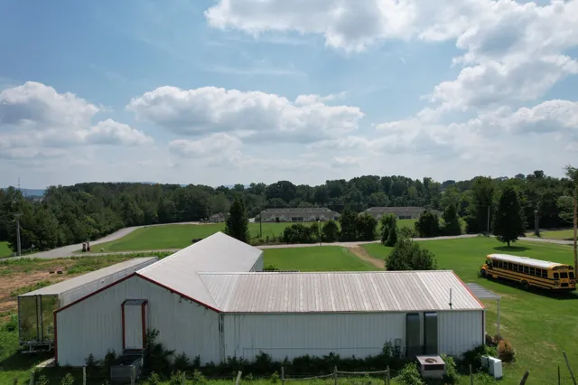 an aerial view of a house having yard and green space