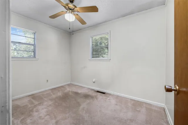 a view of room with stairs and a chandelier fan