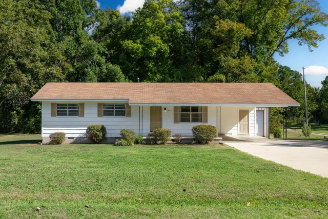 a view of a house with sitting area and garden
