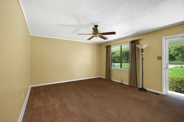 a view of room with window and ceiling fan