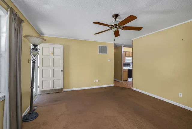a view of a room with a ceiling fan