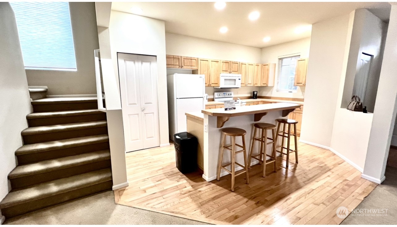 17058 166th Place Southeast Renton, WA 98058 - Photo 7 of 17 a view of kitchen with stainless steel appliances kitchen island granite countertop a refrigerator and a stove top oven