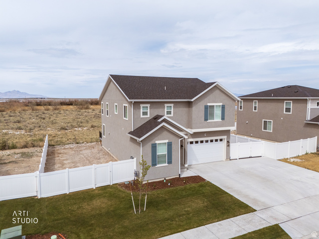 540 Lefty Lane Tooele, UT 84074 - Photo 44 of 48 Traditional home with a gate, a garage, driveway, stucco siding, and a shingled roof