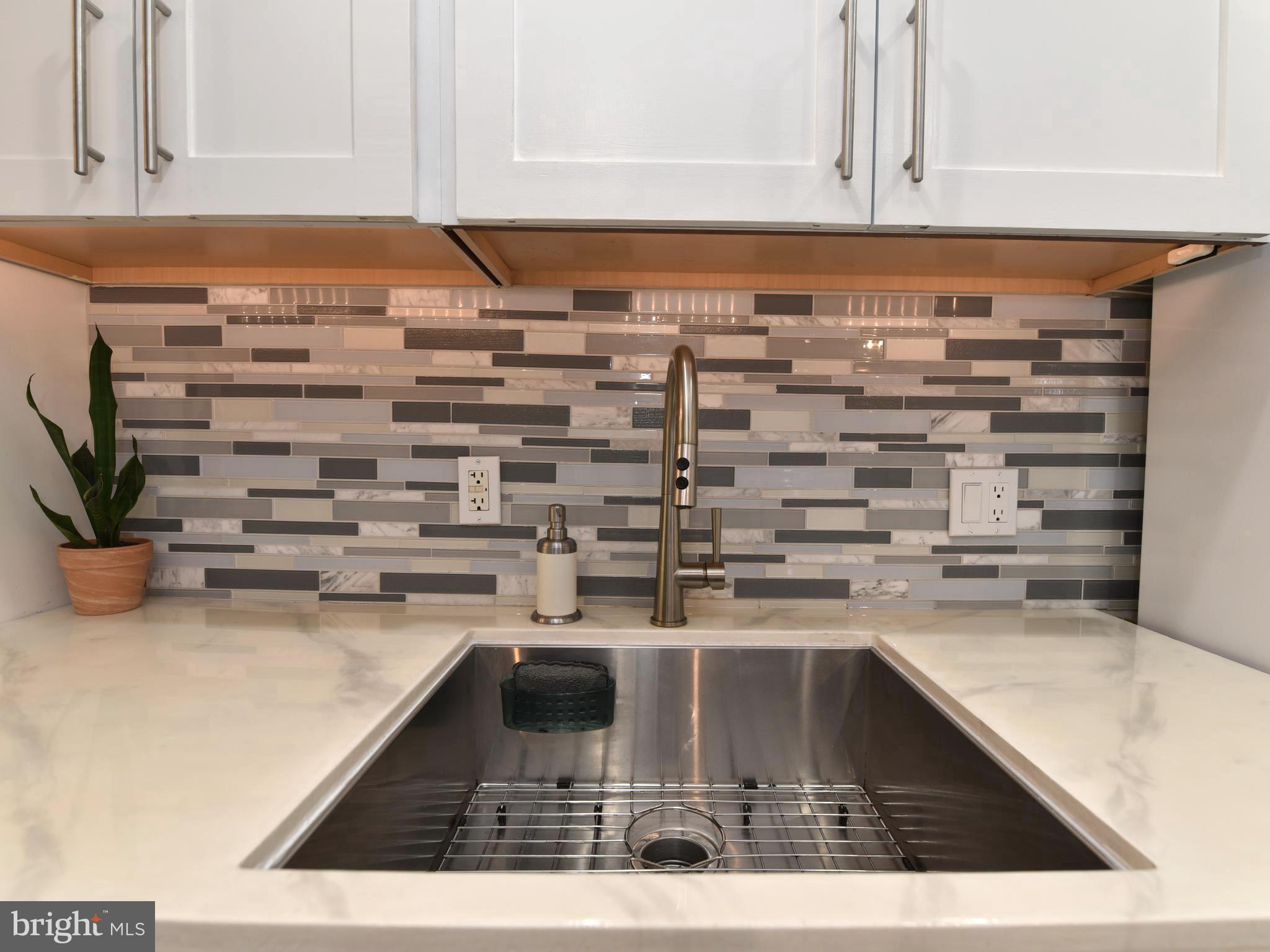 2235 Castle Rock Square, Unit 1B Reston, VA 20191 - Photo 5 of 26 Kitchen sink w/ under cabinet lights & backsplash