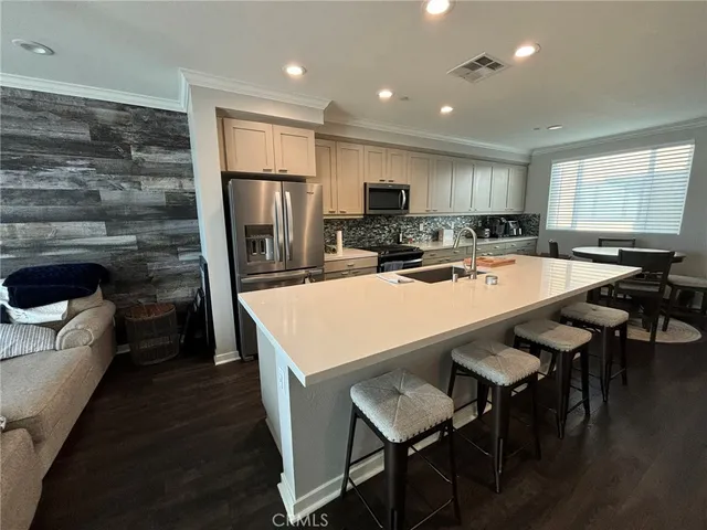 a kitchen with a table chairs refrigerator and cabinets