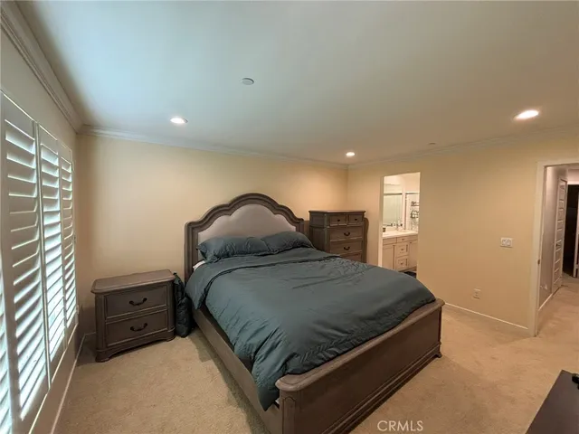 a bedroom with a bed and a night stand
