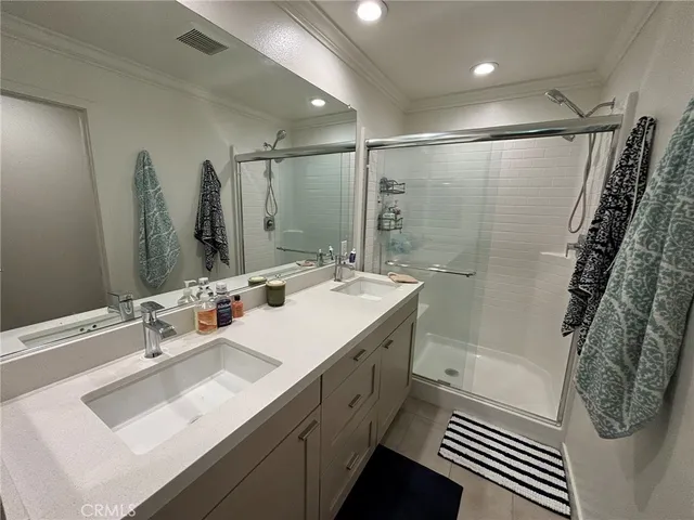 a bathroom with double vanity sink and a mirror