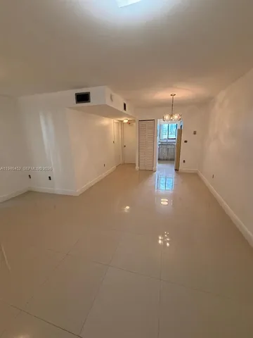 wooden floor in an empty room with a ceiling fan