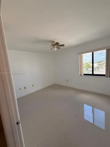 an empty room with a empty space and windows