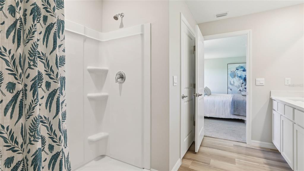 4640 Connection Road Wildwood, FL 34785 - Photo 20 of 30 a en suite bathroom with a toilet sink and shower curtain