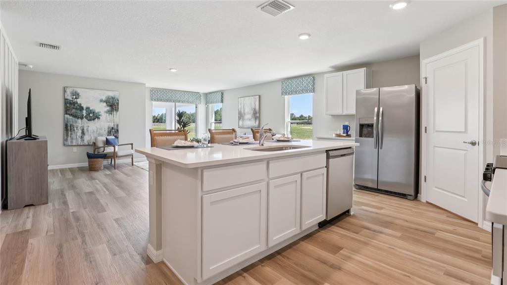 4640 Connection Road Wildwood, FL 34785 - Photo 6 of 30 a kitchen with stainless steel appliances granite countertop a sink stove and refrigerator