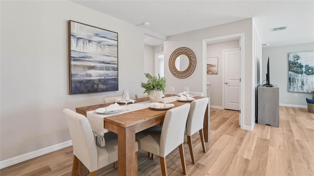 4640 Connection Road Wildwood, FL 34785 - Photo 10 of 30 a dining room with a wooden table and chairs