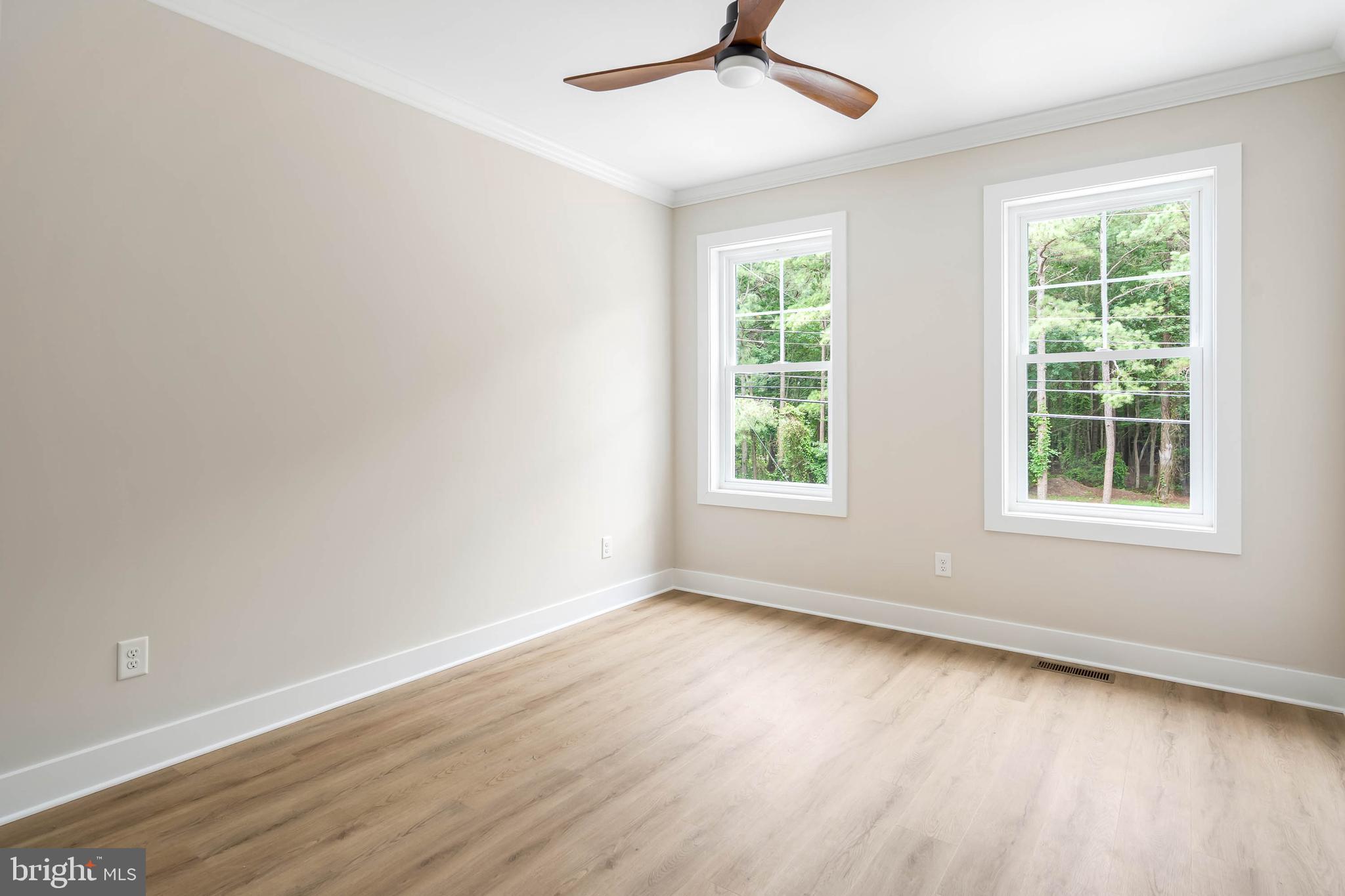 38697 Fred Hudson Road Bethany Beach, DE 19930 - Photo 21 of 51 an empty room with wooden floor fan and windows
