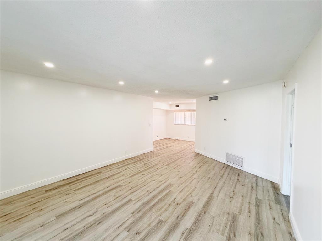 2710 Riverside Drive, Unit 201 Coral Springs, FL 33065 - Photo 11 of 37 a view of empty room with wooden floor