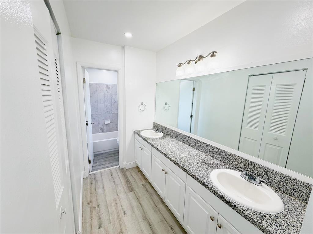 2710 Riverside Drive, Unit 201 Coral Springs, FL 33065 - Photo 21 of 37 a spacious bathroom with a granite countertop sink mirror and a shower