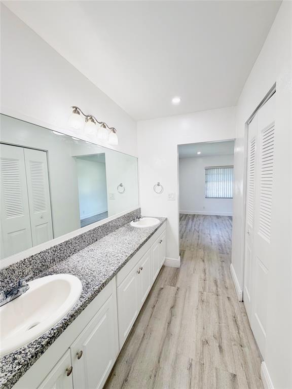 2710 Riverside Drive, Unit 201 Coral Springs, FL 33065 - Photo 22 of 37 a spacious bathroom with a granite countertop sink and a mirror